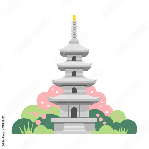 緑とピンクの花がある庭の石塔