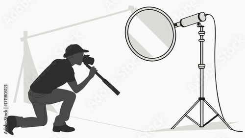 Silhouette of a photographer kneeling and using a camera with a reflector and lighting equipment in a studio setup.