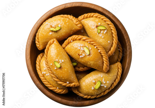 Delicious gujarati sweet gujiya pastries in a wooden bowl top view isolated on transparent background