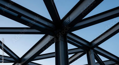 Steel Girder Structure with Rivets Against a Pale Blue Sky Intersecting Metal Beams Forming an Industrial Framework Under Sunny Sky Architecture Concept