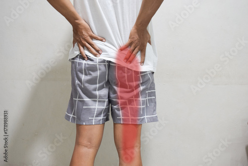sciatica pain concept with young man from button pain spreading to down leg
