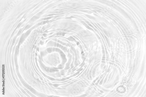 White water with ripples on the surface. Defocus blurred transparent white colored clear calm water surface texture with splashes and bubbles. Water waves with shining pattern texture background.