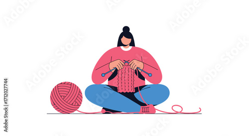 A person is sitting cross legged and knitting with a large ball of yarn beside them.