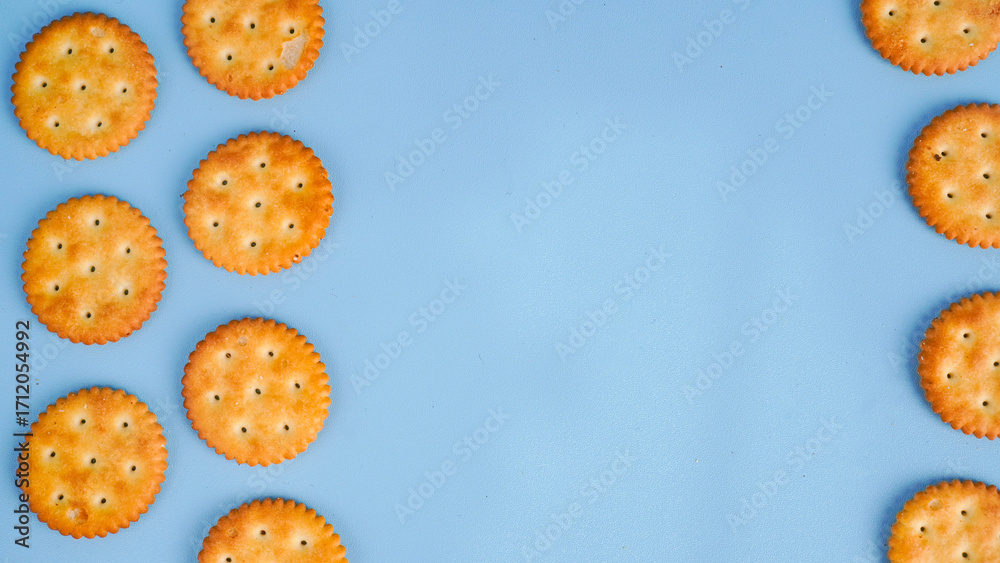 Fototapeta premium Flat lay view of biscuit on light blue background