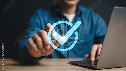 Wallpaper Mural Businessman interacting with digital checkmark symbolizing data validation and compliance over a laptop computer. Torontodigital.ca