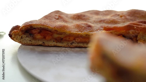 Empanada gallega, a delicious Spanish savory pie filled with tender onion, pepper and tomato and octopus