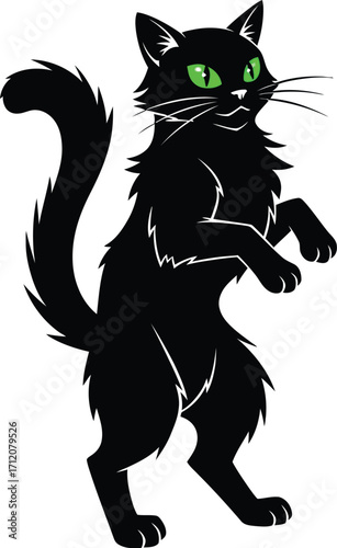 Playful black cat with bright green eyes stands on hind legs, ready for fun.