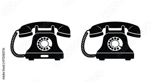 Two vintage rotary phones in black silhouette side by side