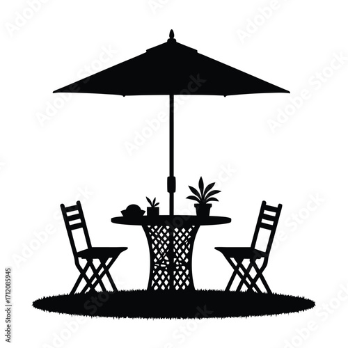 Black silhouette of patio table chairs and umbrella on grass