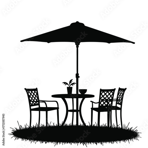 Black silhouette of patio table chairs and umbrella on grass