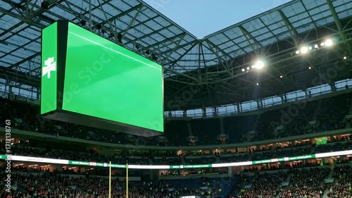 Modern Sports Stadium Interior with Giant Green Screen Jumbotron Ready for Event Content and Advertising, Overlooking Spectator Seating