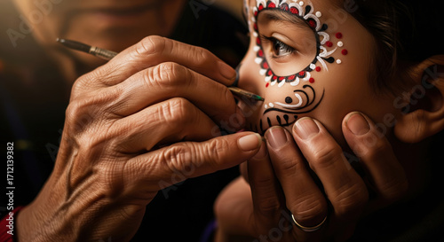 Artist painting a child's face with sugar skull makeup for Dia de los Muertos. Concept of Mexican culture and tradition.