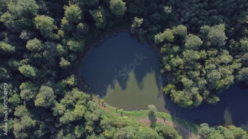 Top down view of a lake surrounded by dense forestry in Dilijan, Armenia. Lake Parz tourist destination for hiking and boating.