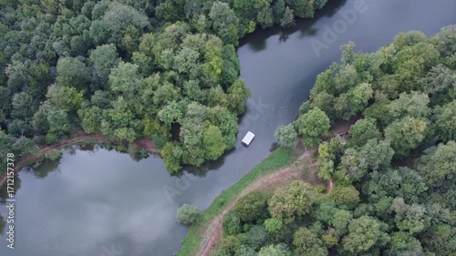Top down view of a boat passing through a narrow river passage in Dilijan, Armenia. Tourist destination in dense nature.