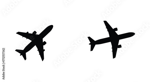 Two black silhouettes of airplanes viewed from directly above