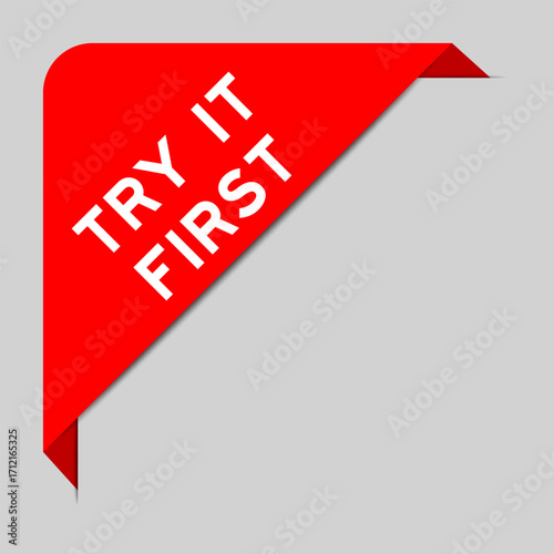 Red color of corner label banner with word try it first on gray background
