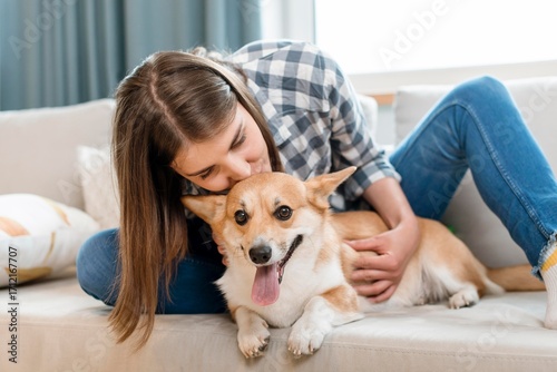 A happy young woman and her dog sitting together, sharing a moment of pure love and friendship