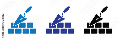 Construction trowel icon on a brick wall in blue and black, isolated on white background