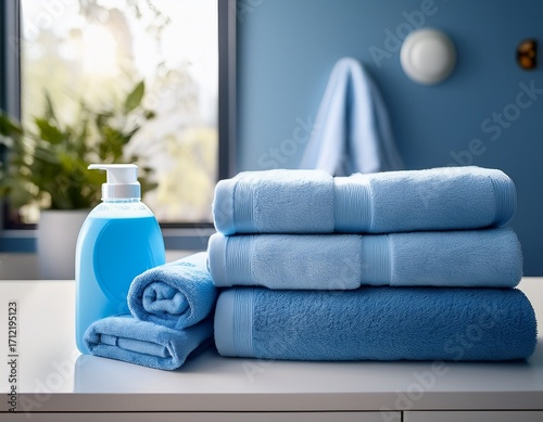 Wallpaper Mural stacked fluffy blue bath towels rolled hand towels and a bottle of laundry detergent resting on a white surface in a modern laundry room with natural light Torontodigital.ca