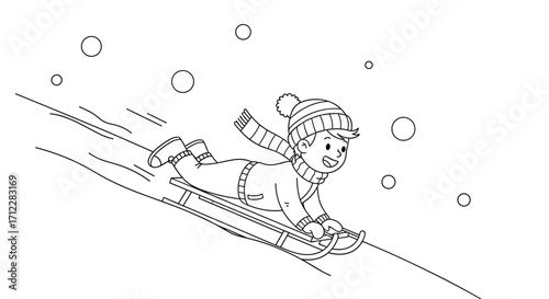A happy child sliding down a snowy hill on a sled.