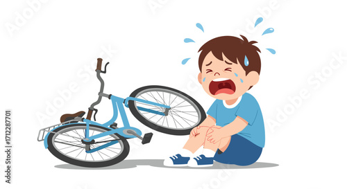 A young boy is crying because he fell off his bicycle.