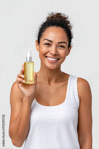 Smiling woman holding glass bottle with cosmetic oil serum, natural skincare routine, clean white background, healthy glowing skin, confident expression, beauty lifestyle