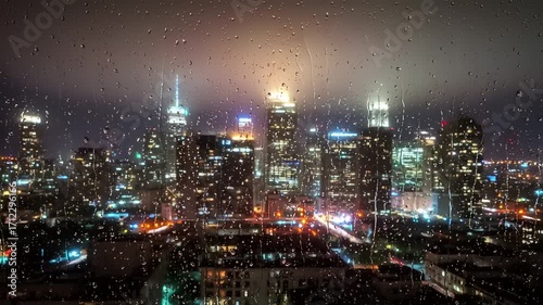 Wallpaper Mural Nighttime cityscape of a vibrant urban skyline illuminated by lights and rain-soaked windows Torontodigital.ca