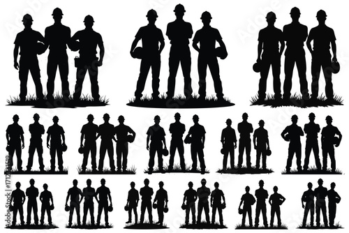 Black silhouettes of construction workers standing in grass