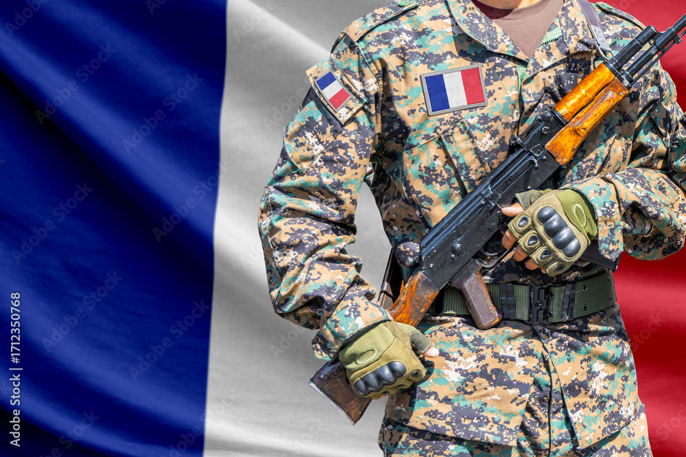 Fototapeta premium France flag with soldier holding assault rifle