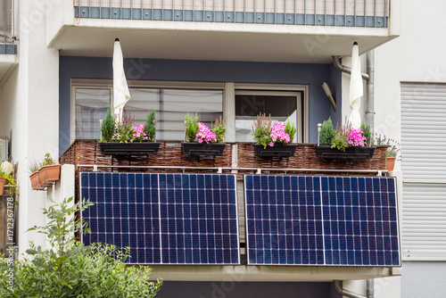 Balcony Solar Panels of Modern Apartment Building Facade. Small Mini Solar Panel Station on Modern Balcony Railings. 