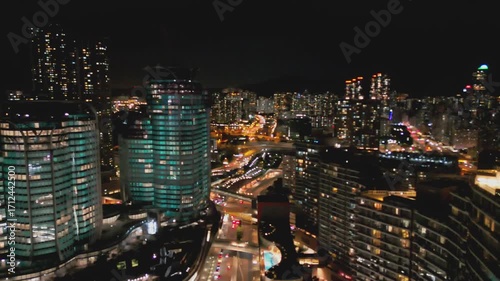 Wallpaper Mural Drone footage of Hong Kong at night. Showcasing glowing skyscrapers, bustling streets, and city lights. Ideal for travel, urban, and skyline projects highlighting nighttime energy. Torontodigital.ca