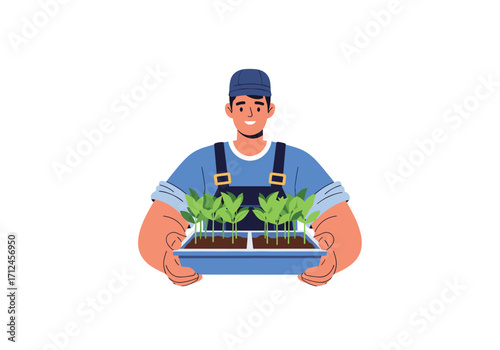 A gardener holding a tray of young plants.