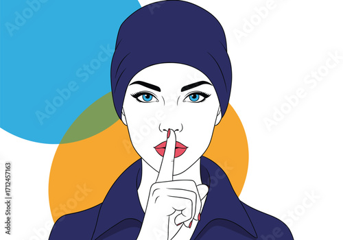 Woman wearing a beanie and jacket with her finger to her lips.