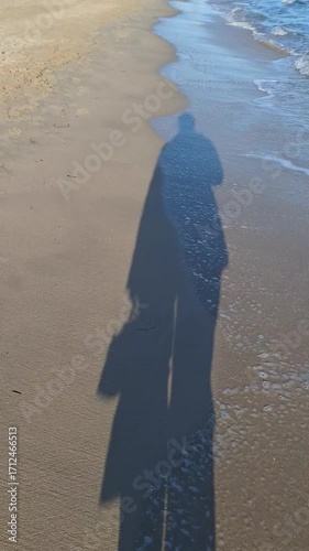 Shadow walking on the beach