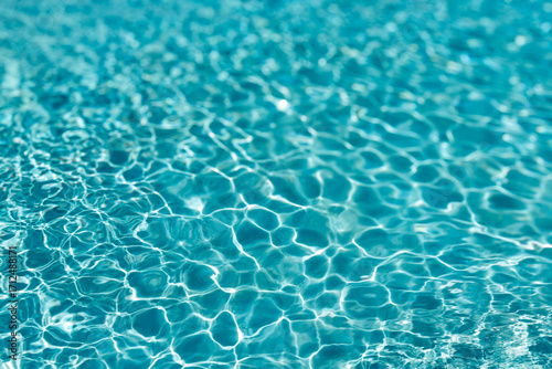 Background of rippled pattern of clean water in a blue swimming pool