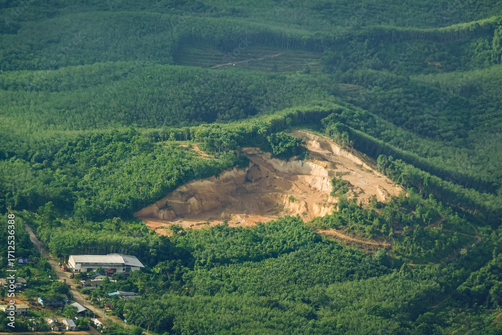 Obraz premium Mountains with green forests are being destroyed for urban growth