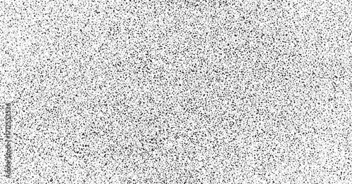 Speckled abstract background with black spots on white surface resembling a terrazzo texture