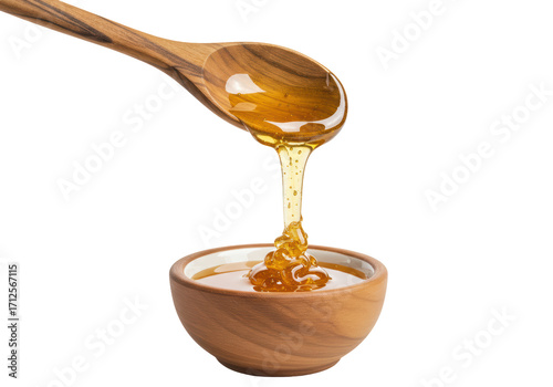 Canvas Print Isolated golden honey drips from wooden spoon into wooden bowl, dripping honey s
