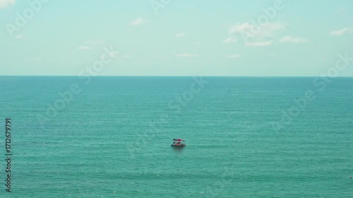 Blue Sea Azure Sky White Clouds and a Catamaran with Tourists on a Sunny Summer Day. Vacation, Leisure, Tourism.