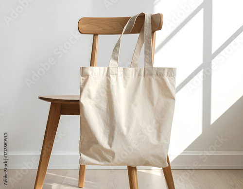 Beige Fabric Tote Bag Mockup on a Wooden Chair with Natural Lighting