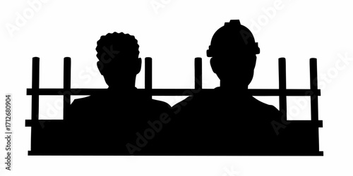 Silhouette of two construction workers, one with a hardhat, looking out from a fenced area