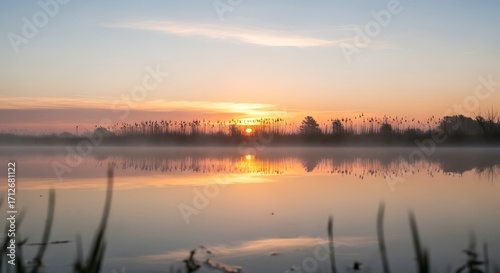 Sunrise over Calm Lake with Misty Trees.