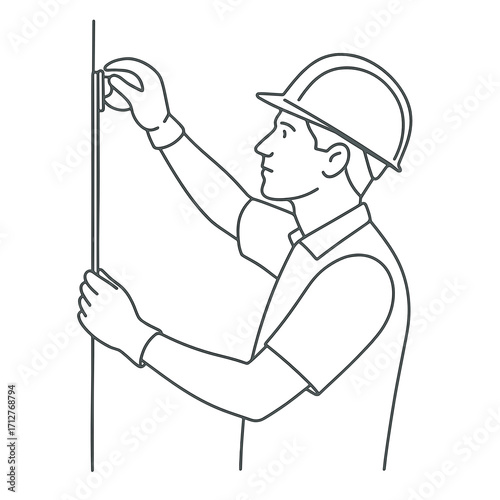 Worker measuring wall size while wearing construction helmet  