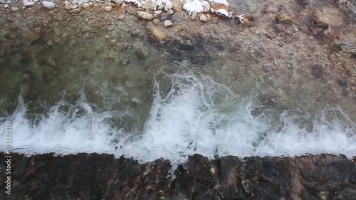 Flowing water of cascade waterfall in winter .