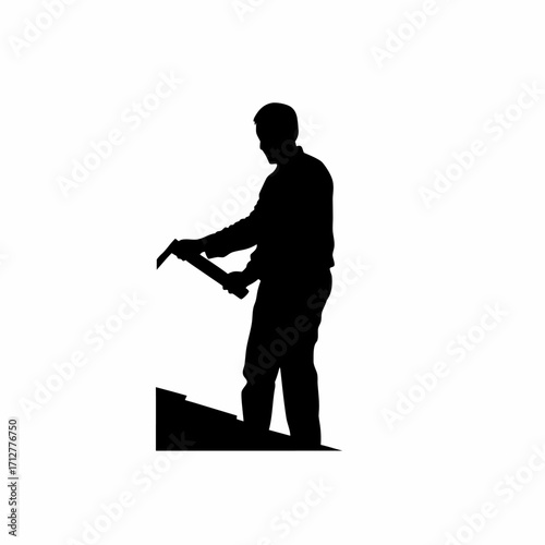 Silhouette of roofing installer with hand saw trimming sheet isolated on white background