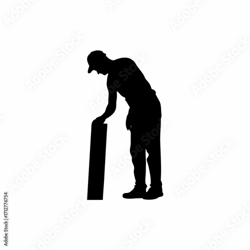 Silhouette of roofing sheet installer leaning forward to align sheet isolated on white background