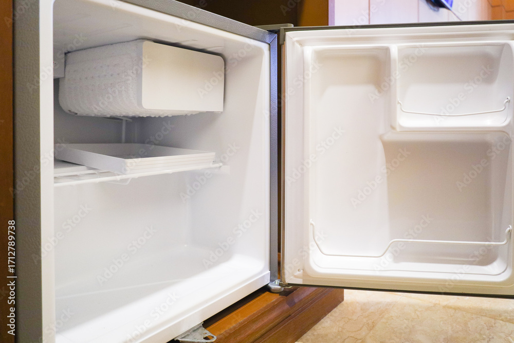 Fototapeta premium Bright Empty Mini Refrigerator with Open Door Interior Appliance View