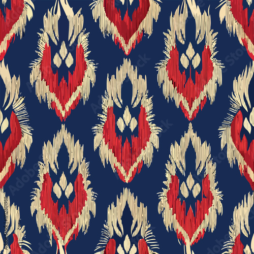 Red and cream ikat pattern on navy blue background textile fabric