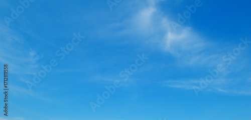 Serene blue sky with wispy clouds
