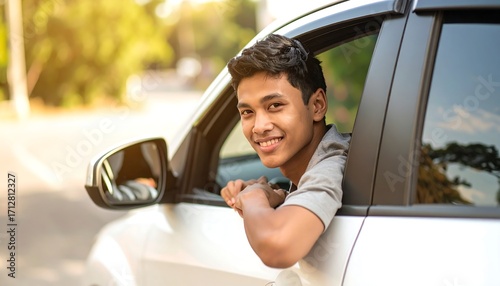 Smiling teen leans out car window